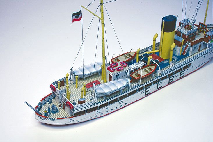 Photo of HMV Pilot Boat Ditmar Koel 1:250 scale paper model kit showing detailed parts and completed model of the 1935 German pilot vessel.