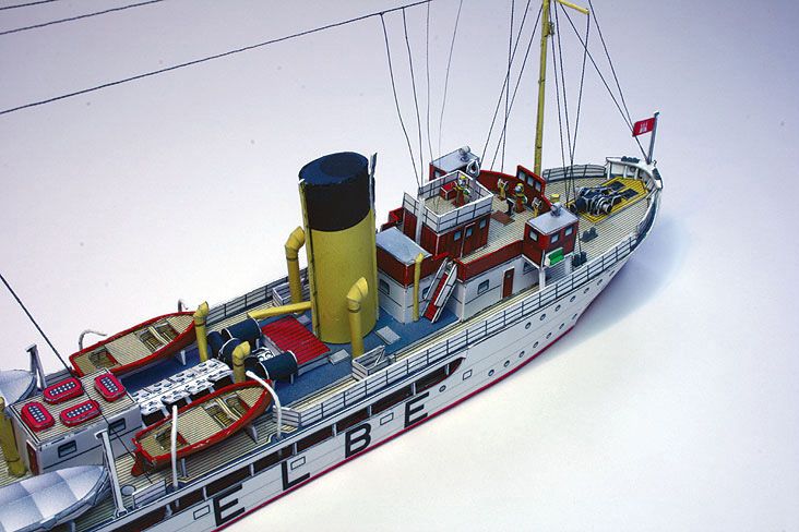 Photo of HMV Pilot Boat Ditmar Koel 1:250 scale paper model kit showing detailed parts and completed model of the 1935 German pilot vessel.