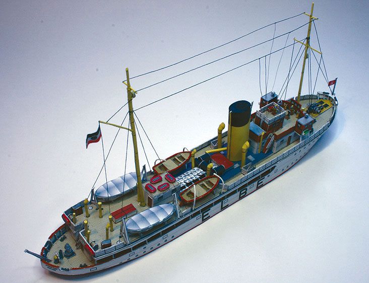 Photo of HMV Pilot Boat Ditmar Koel 1:250 scale paper model kit showing detailed parts and completed model of the 1935 German pilot vessel.