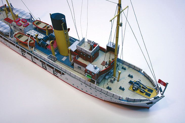 Photo of HMV Pilot Boat Ditmar Koel 1:250 scale paper model kit showing detailed parts and completed model of the 1935 German pilot vessel.