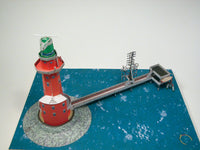 Photo of HMV Hohe Weg Aussenweser Lighthouse 1:250 card model kit showing detailed paper parts, wind semaphore, and water base.