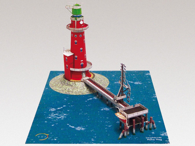 Photo of HMV Hohe Weg Aussenweser Lighthouse 1:250 card model kit showing detailed paper parts, wind semaphore, and water base.