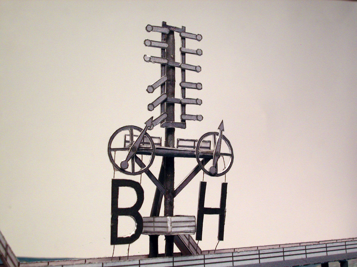 Photo of HMV Hohe Weg Aussenweser Lighthouse 1:250 card model kit showing detailed paper parts, wind semaphore, and water base.