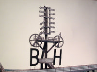 Photo of HMV Hohe Weg Aussenweser Lighthouse 1:250 card model kit showing detailed paper parts, wind semaphore, and water base.