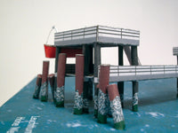 Photo of HMV Hohe Weg Aussenweser Lighthouse 1:250 card model kit showing detailed paper parts, wind semaphore, and water base.