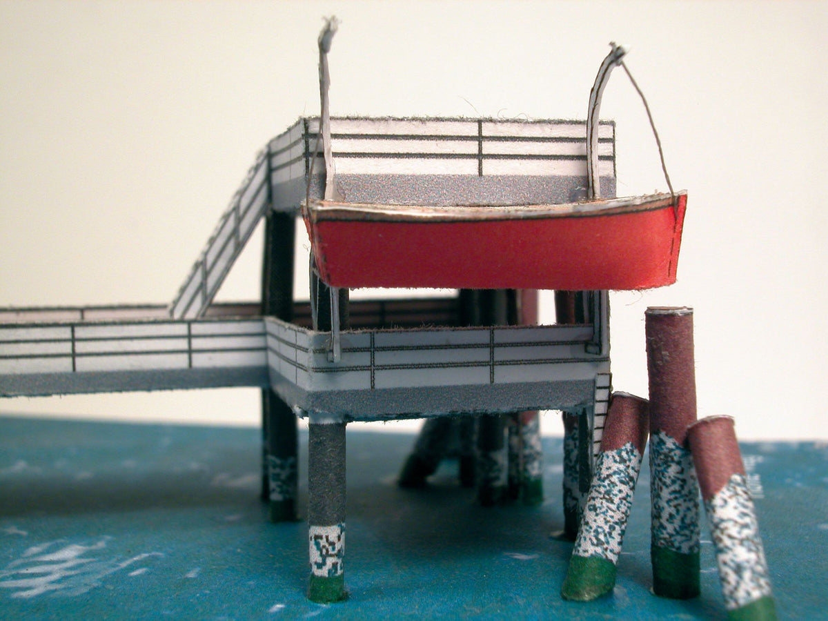 Photo of HMV Hohe Weg Aussenweser Lighthouse 1:250 card model kit showing detailed paper parts, wind semaphore, and water base.