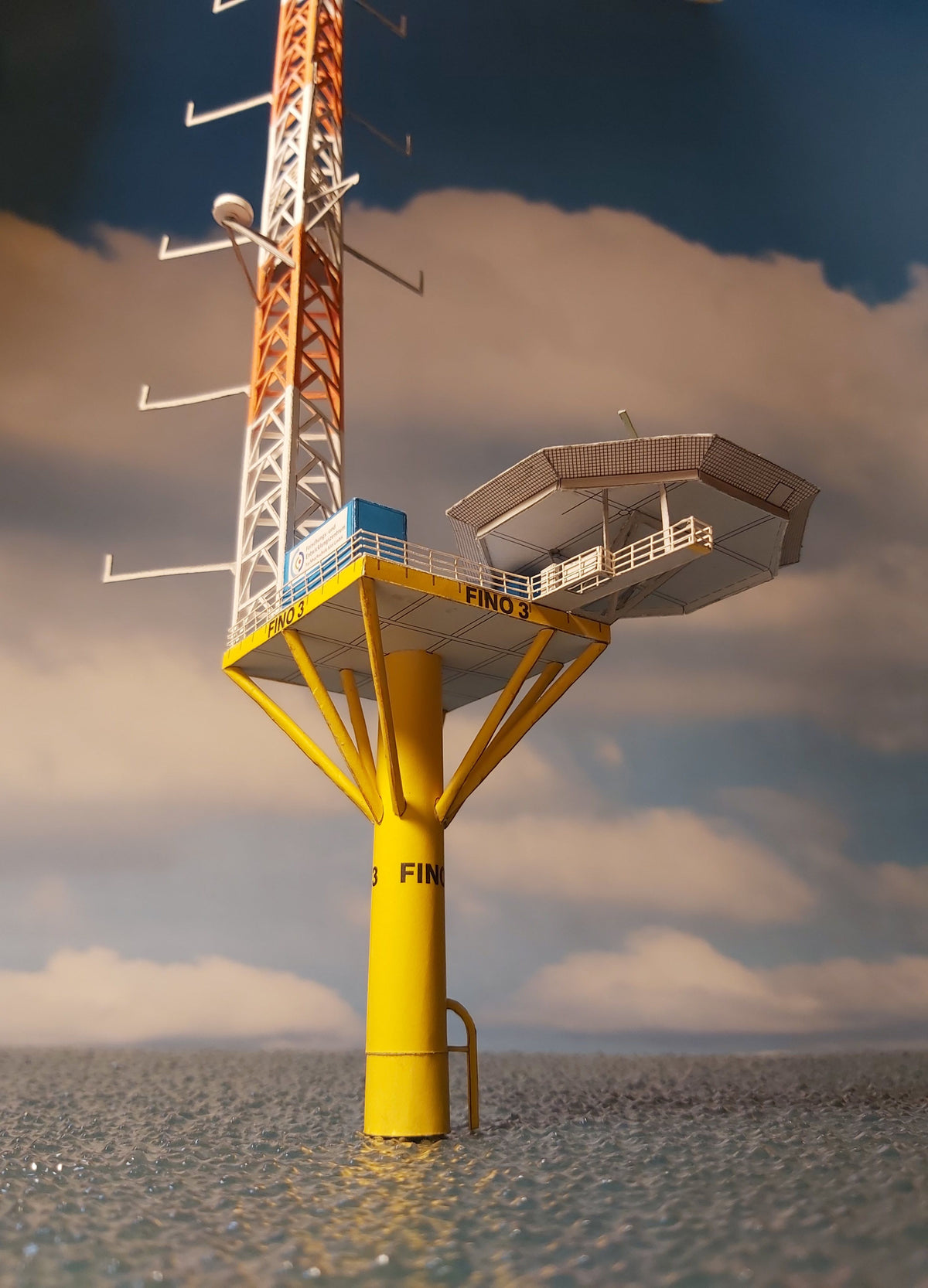 Photo of HMV Research Platform FINO 3 paper model kit in 1:250 scale with helicopter and ocean base