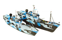 Two remote control model fishing boats with a blue, gray, and black camouflage pattern, featuring a skull and crossbones logo and the name 'STIVE RAWIN 77' on the hulls, shown against a solid white background.