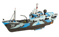 A Steve Owen Sea Shepherd RC model yacht on a white background, featuring a blue, gray, and black camouflage pattern with the number 77 on the hull.