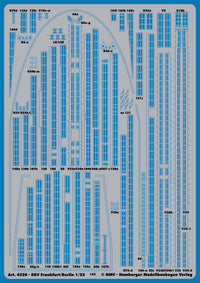 A blue and white plastic model train decal sheet from KMW (Hamburger Modellbaufen Verlag), featuring various printed labels, numbers, and markings for model trains, with text indicating scale 1:22.