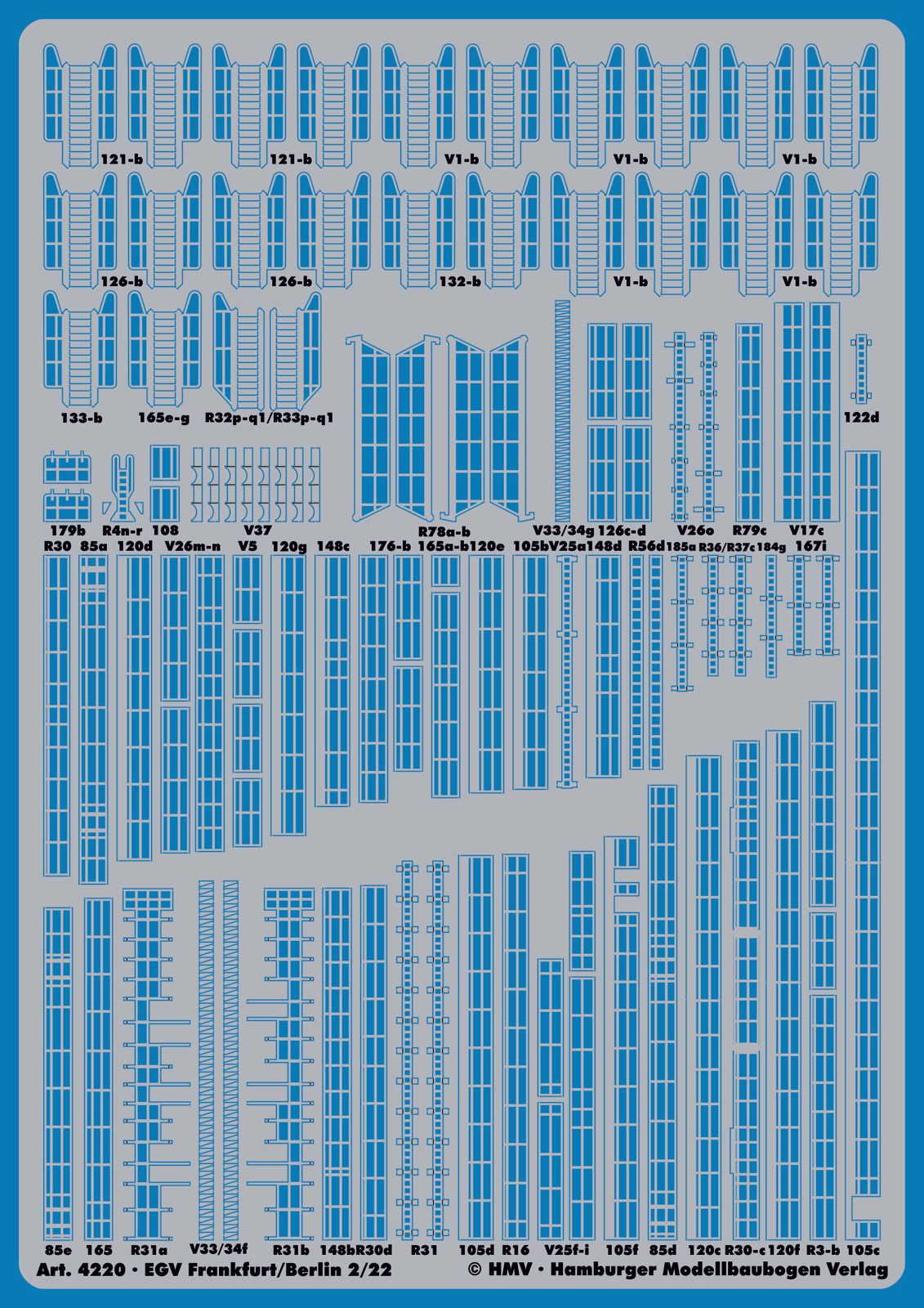 A blue model train layout sheet with numerous small printed track and signal plan markings, photographed flat against a matching blue background.