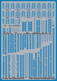 A blue model train layout sheet with numerous small printed track and signal plan markings, photographed flat against a matching blue background.