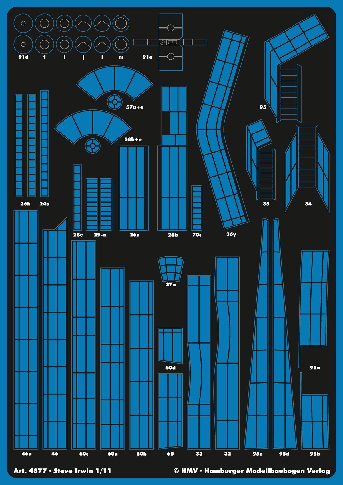 A sheet of blue and black model kit decals or templates with many pre-cut geometric panel shapes and labels, shown flat against a dark background. Visible text includes 'Art.
