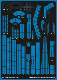 A sheet of blue and black model kit decals or templates with many pre-cut geometric panel shapes and labels, shown flat against a dark background. Visible text includes 'Art.