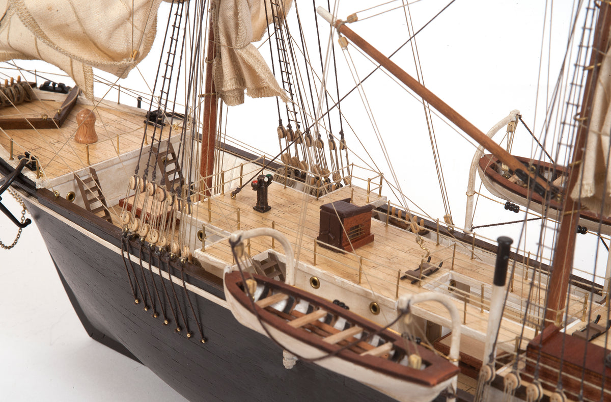 Photo of OcCre Endurance 1:70 wooden model ship kit with sails, nameplate, and detailed wooden construction