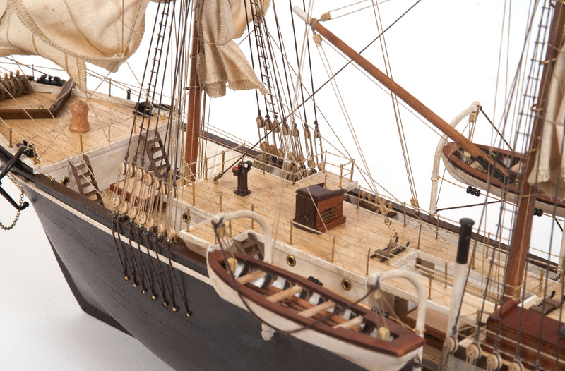 Photo of OcCre Endurance 1:70 wooden model ship kit with sails, nameplate, and detailed wooden construction