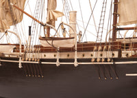 Photo of OcCre Endurance 1:70 wooden model ship kit with sails, nameplate, and detailed wooden construction