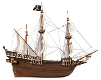 Photo of OcCre Buccaneer Pirate Ship 1:100 Wooden Model Kit fully assembled, showing detailed sails, wooden hull, and rigging.