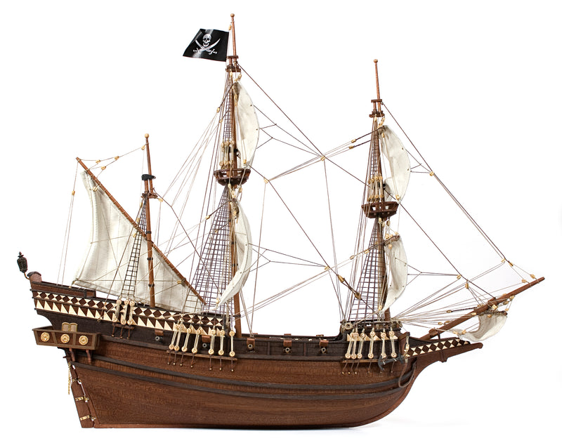 Photo of OcCre Buccaneer Pirate Ship 1:100 Wooden Model Kit fully assembled, showing detailed sails, wooden hull, and rigging.
