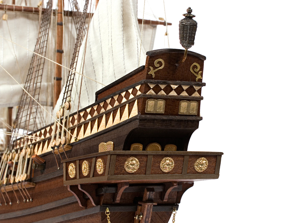 Photo of OcCre Buccaneer Pirate Ship 1:100 Wooden Model Kit fully assembled, showing detailed sails, wooden hull, and rigging.