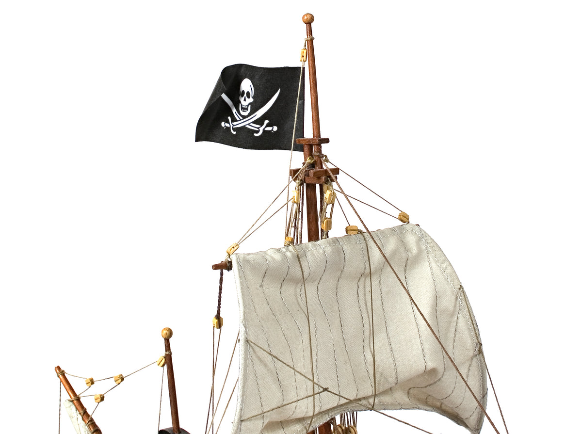Photo of OcCre Buccaneer Pirate Ship 1:100 Wooden Model Kit fully assembled, showing detailed sails, wooden hull, and rigging.