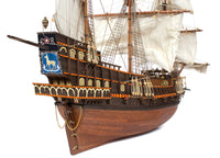 Photo of OcCre Golden Hind 1:85 wooden model ship kit showing detailed wooden hull and historical galleon design.
