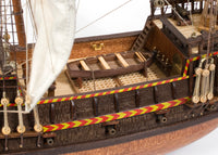 Photo of OcCre Golden Hind 1:85 wooden model ship kit showing detailed wooden hull and historical galleon design.