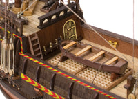Photo of OcCre Golden Hind 1:85 wooden model ship kit showing detailed wooden hull and historical galleon design.