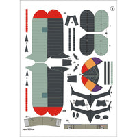 A sheet of cut paper airplane parts laid out on a white background, including wings, tail sections, nose pieces, and small decals with printed labels and measurements.