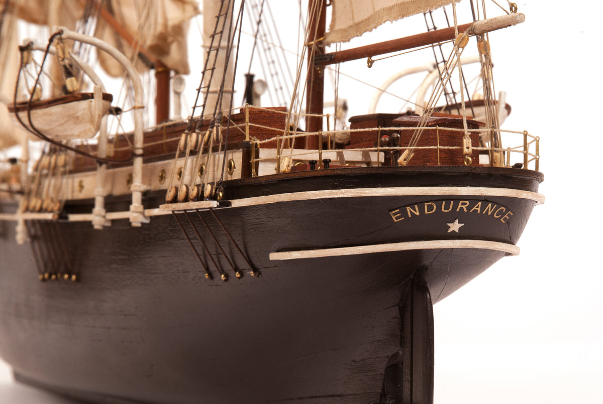 Photo of OcCre Endurance 1:70 wooden model ship kit with sails, nameplate, and detailed wooden construction