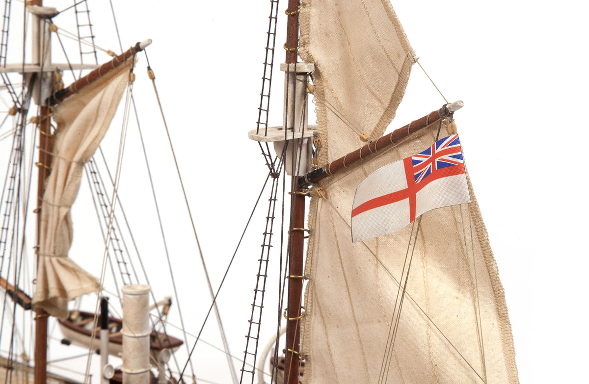 Photo of OcCre Endurance 1:70 wooden model ship kit with sails, nameplate, and detailed wooden construction