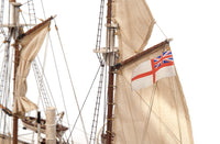 Photo of OcCre Endurance 1:70 wooden model ship kit with sails, nameplate, and detailed wooden construction