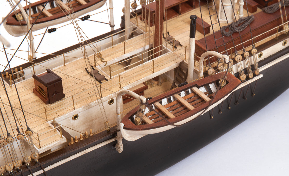Photo of OcCre Endurance 1:70 wooden model ship kit with sails, nameplate, and detailed wooden construction