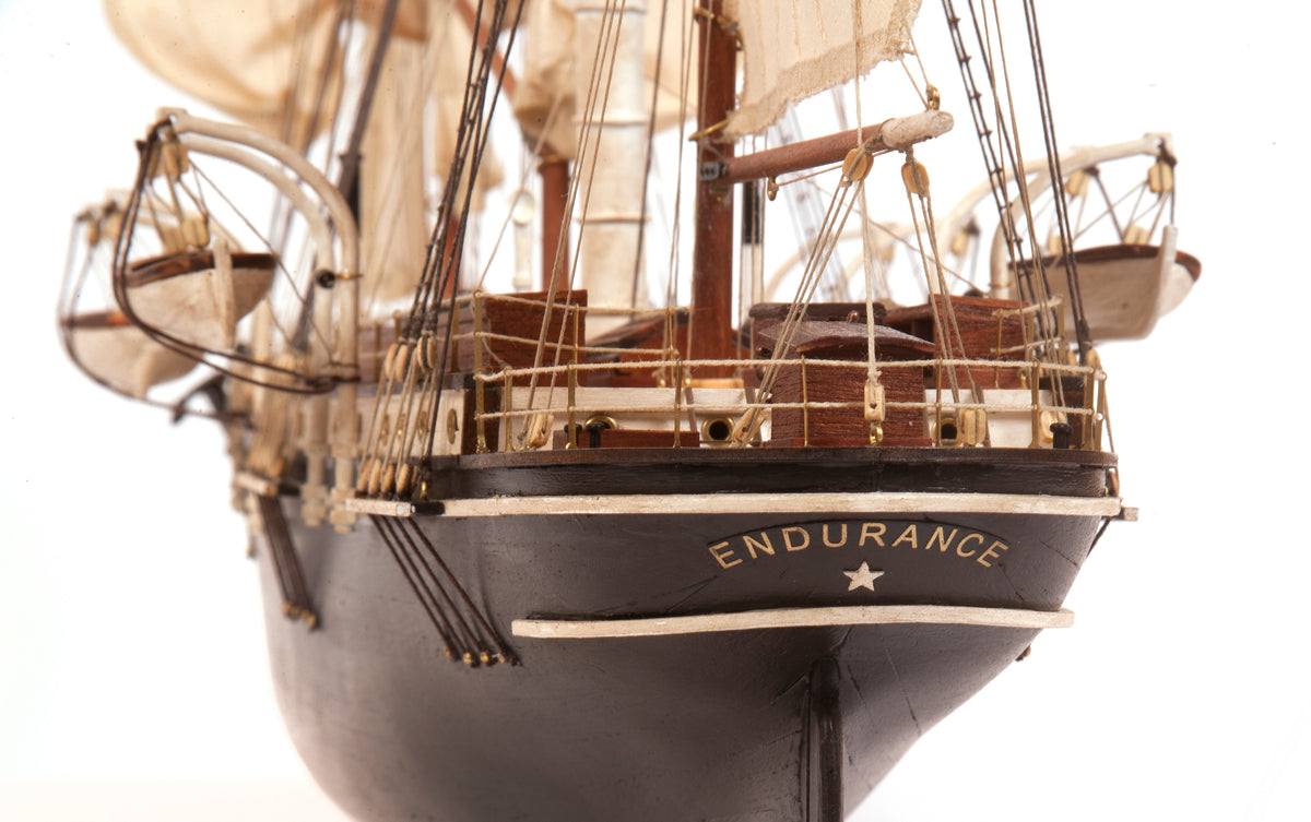 Photo of OcCre Endurance 1:70 wooden model ship kit with sails, nameplate, and detailed wooden construction