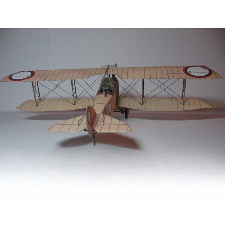 A vintage-style biplane model or miniature aircraft shown from the rear three-quarter view on a plain light gray studio background.