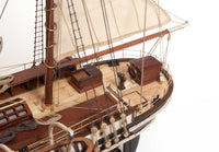 Photo of OcCre Endurance 1:70 wooden model ship kit with sails, nameplate, and detailed wooden construction