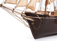 Photo of OcCre Endurance 1:70 wooden model ship kit with sails, nameplate, and detailed wooden construction