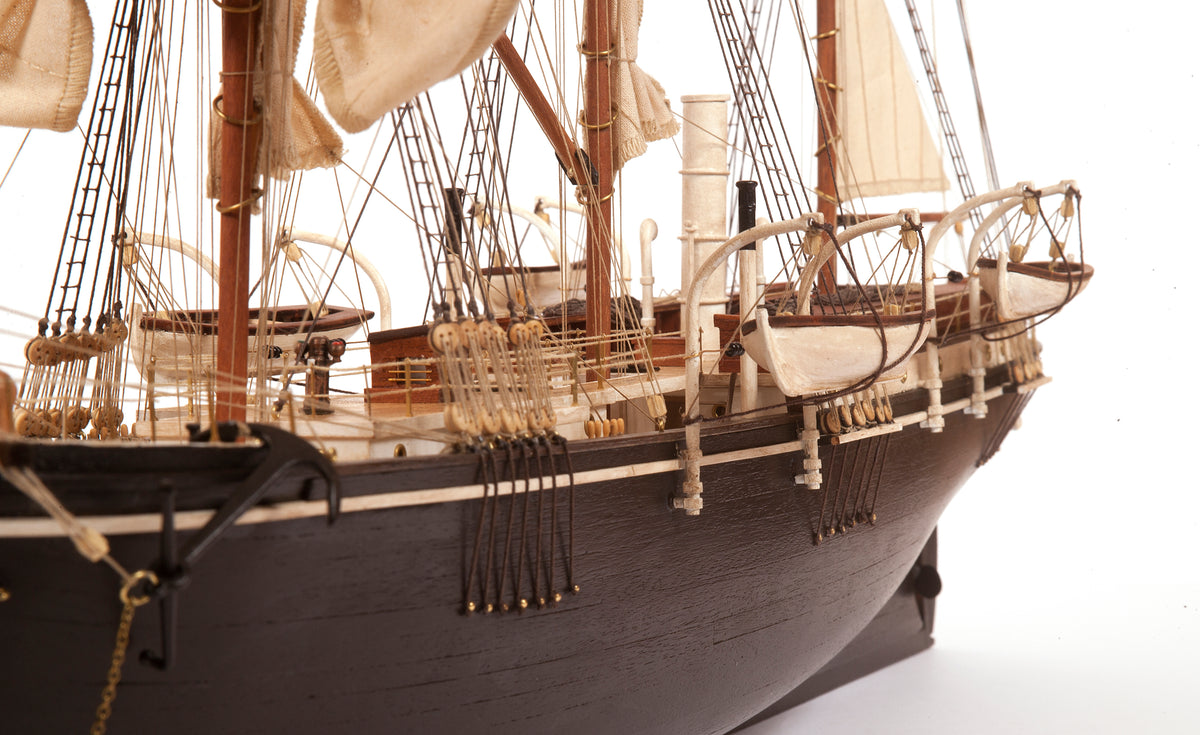 Photo of OcCre Endurance 1:70 wooden model ship kit with sails, nameplate, and detailed wooden construction