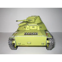 A miniature model of a Soviet T-34 tank car, painted in a light olive green livery with black tracks and silver metal details, photographed against a neutral gray background.