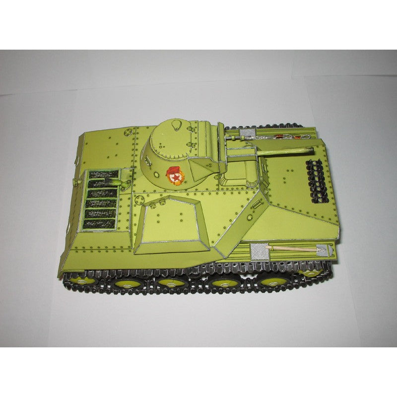 A miniature model of a military tank in olive drab green with black treads and a small red and yellow emblem on the side, photographed on a plain light background.