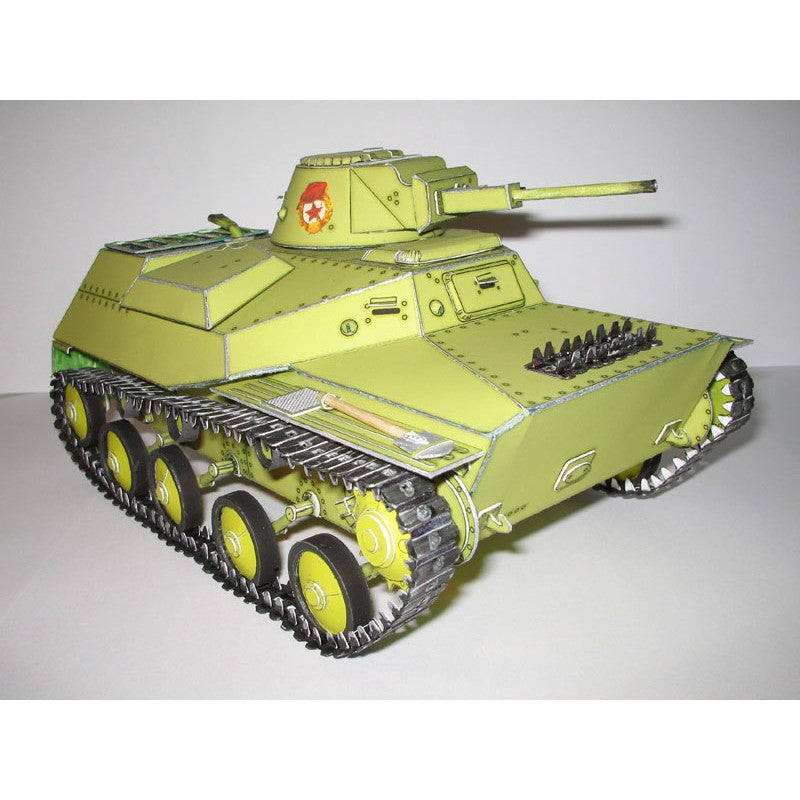 A painted model tank, likely a Japanese light tank, in olive drab green with black treads and wheels, featuring a red and white emblem on the turret.