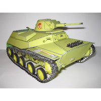A painted model tank, likely a Japanese light tank, in olive drab green with black treads and wheels, featuring a red and white emblem on the turret.