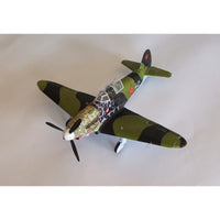 A model of a vintage military fighter plane, likely a Spitfire, featuring a green and black camouflage pattern with red star insignias on the tail, photographed on a plain light background.