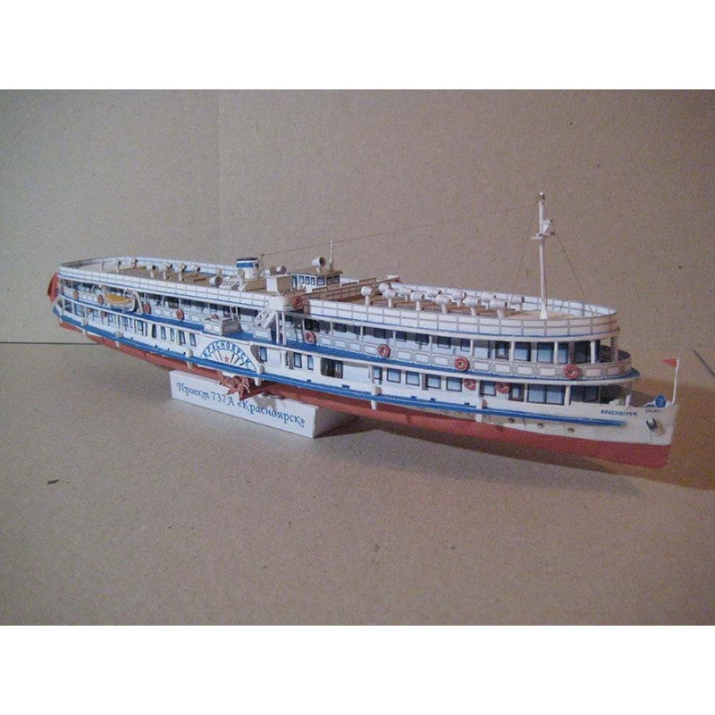 A detailed model of a Russian cruise ship, displayed on a small white stand against a plain beige background.