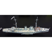 A detailed model of a gray military battleship displayed on a black background.