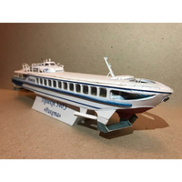 A paper model of a passenger ferry, specifically the Lada-3400 'Raxtma', displayed on a small stand against a plain brown background.