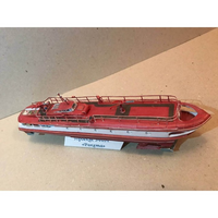 A red and white model of the Soviet passenger ship 'Pargama' on a cardboard display stand, photographed against a neutral cardboard background.