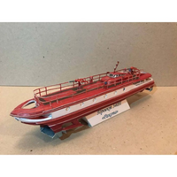 A red and white model of the Soviet cargo ship 'Pocmut' (HMS Pocquot) on a display stand, photographed against a plain beige background.
