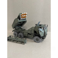 A scale model of an olive green military missile launcher truck with its launcher raised, shown on a neutral beige background.