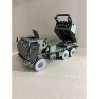 A detailed model of an olive green military tactical truck with a rear-mounted missile launcher, shown on a neutral beige background.